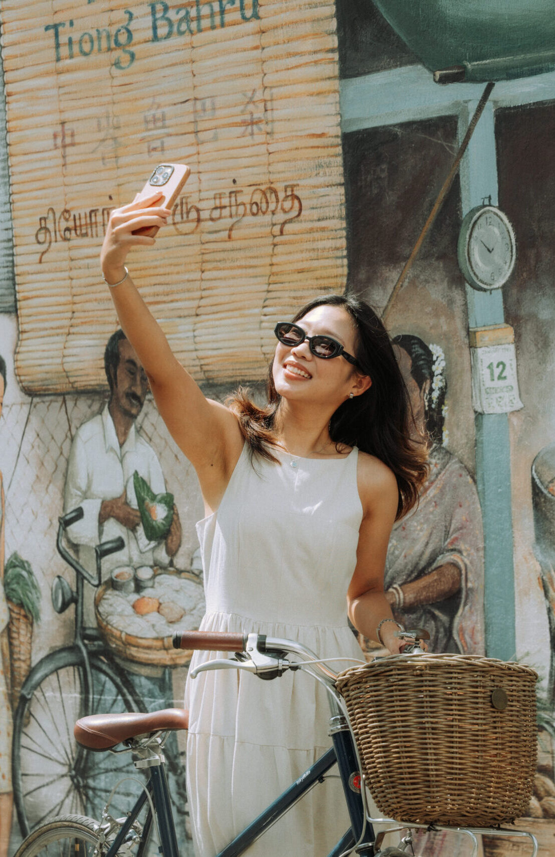 Warehouse Day 01 -64 woman happily taking a selfie beside a bicycle on the side of the road