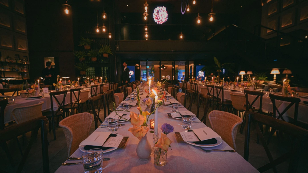indoor hotel banquet with dark lighting and long tables