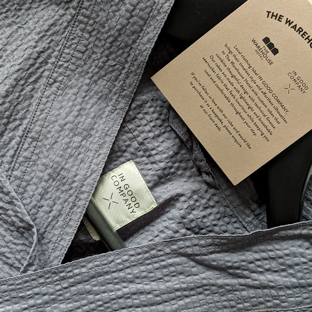 partners-igc-1 closeup of a grey robe on a hanger