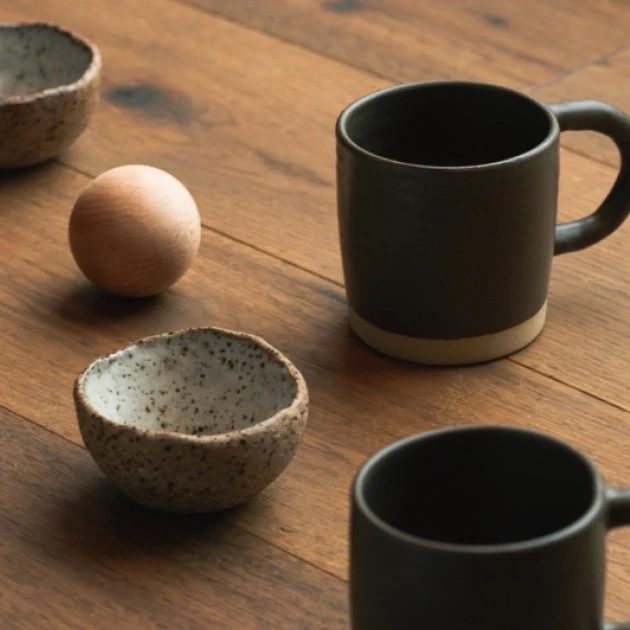partners-mudrock-1 two cups and two saucepans on a wooden table