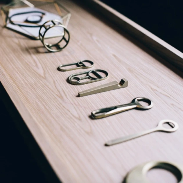 partners-supermama-1 a few metallic bottle openers on a wooden tray