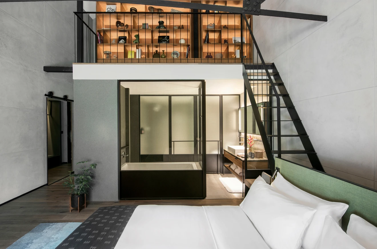 hotel bedroom with an office mezzanine on top and bathroom below
