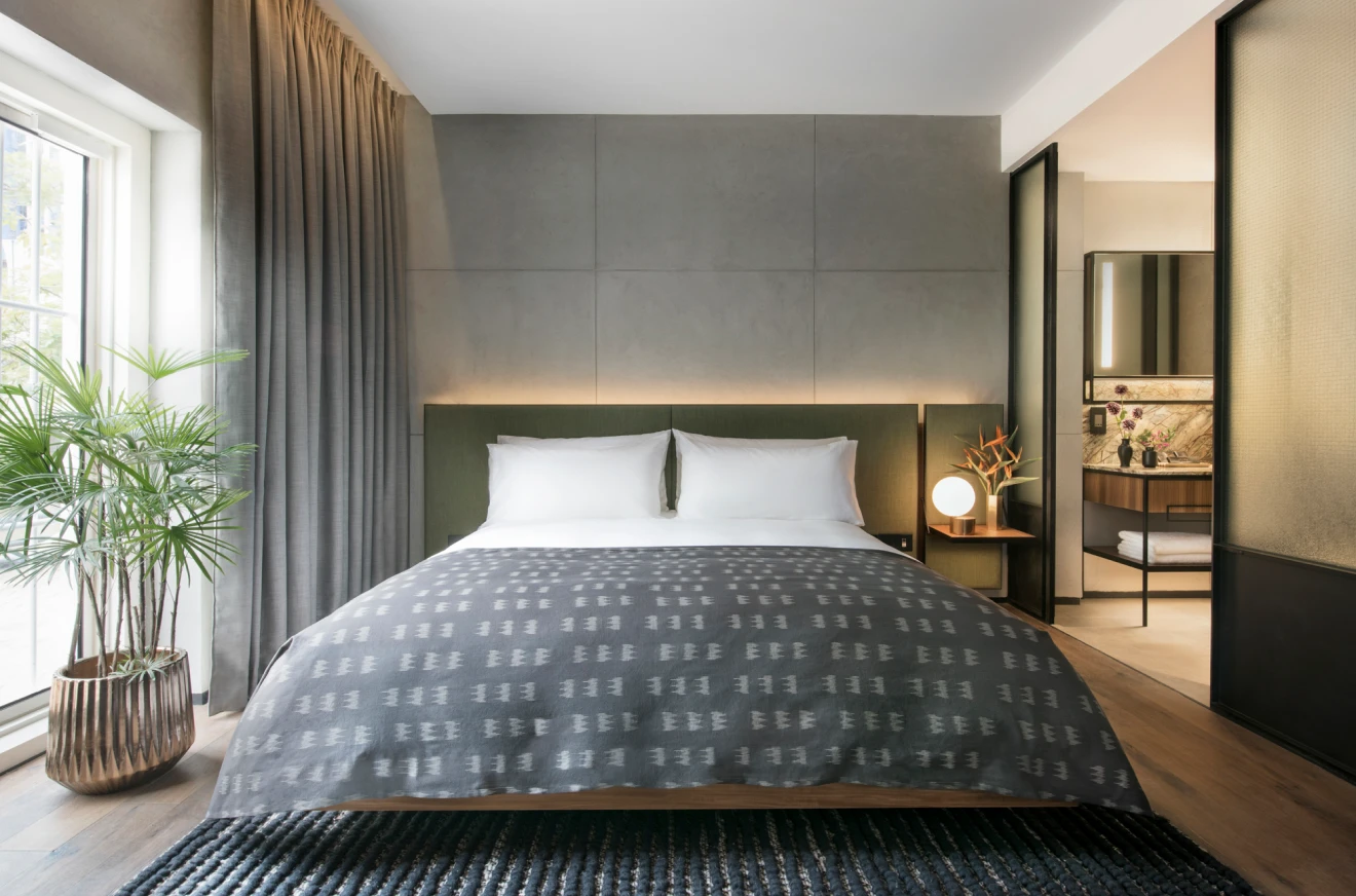blue and grey themed hotel bedroom with en suite