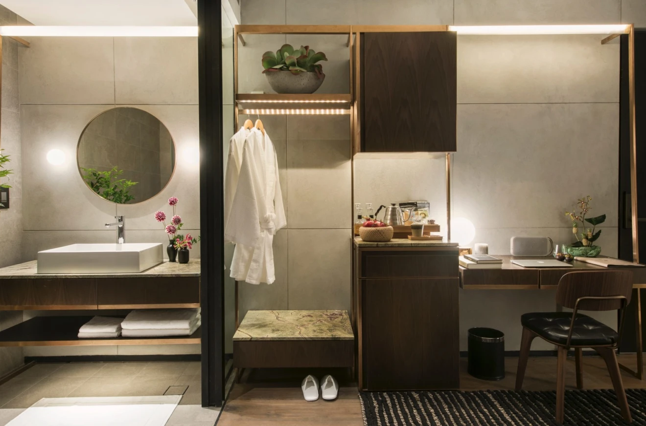 bathroom sink next to an open closet and vanity