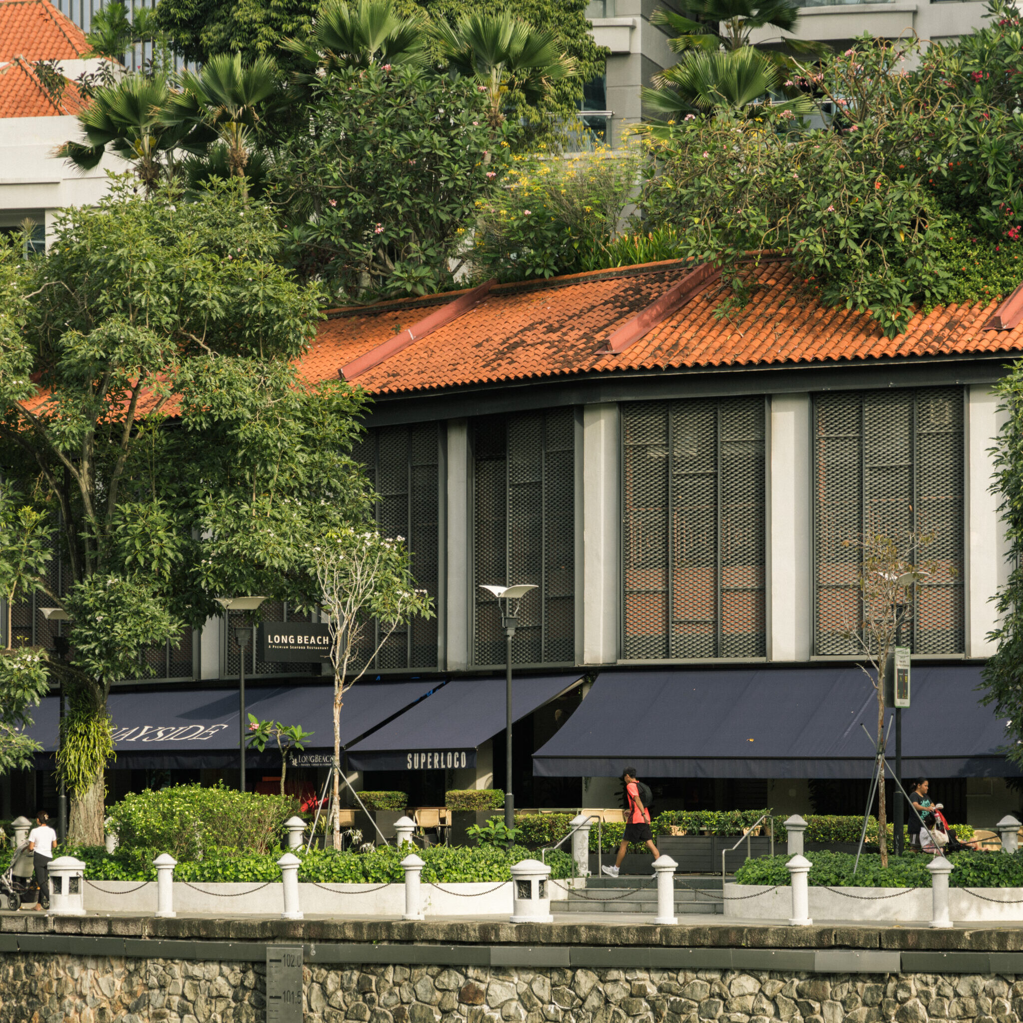 exterior of large white building by the promenade