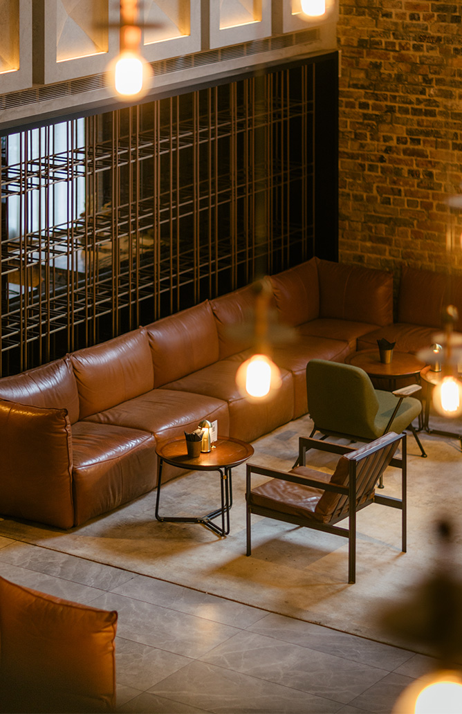 testing industrial style lounge area with brown leather sofa