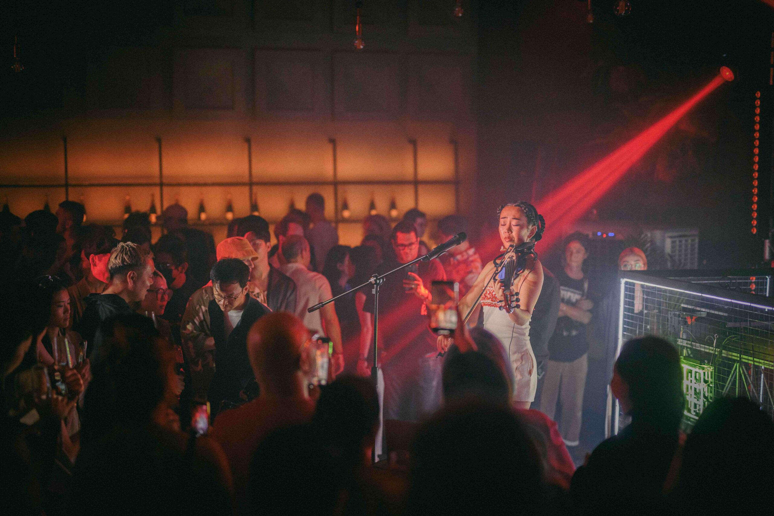 party at unique event space female violinist playing a violin in a crowded hall