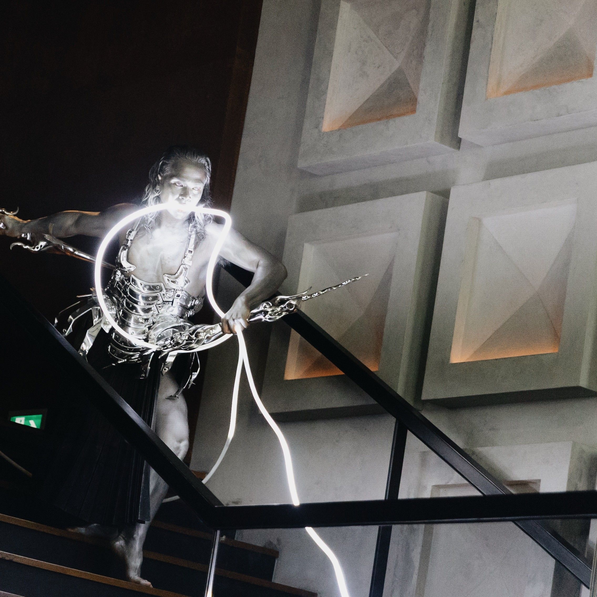 performance at a unique event space a man performing in a silver armour while going down the stairs